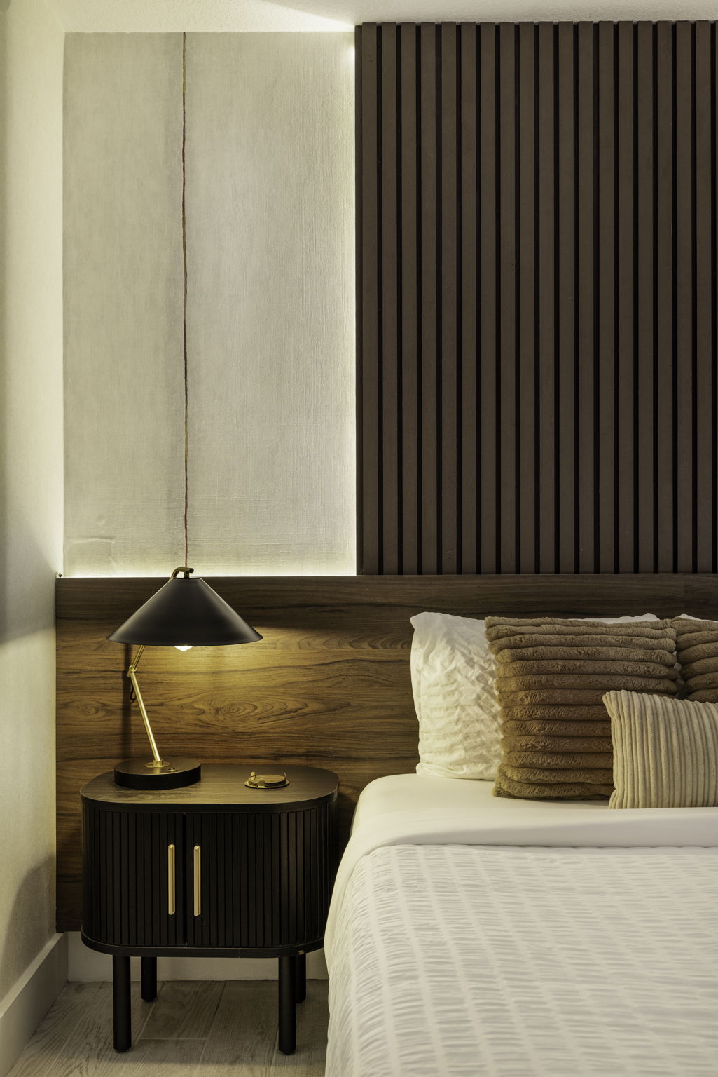 Queen bedroom nightstand and illuminated wood-slat wall