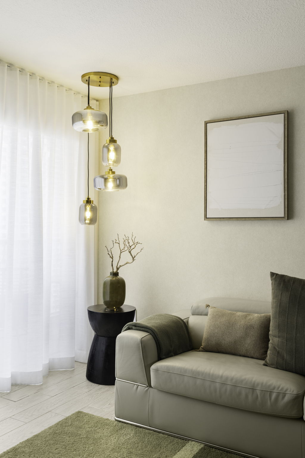 Living room seating beside the floor-to-ceiling windows